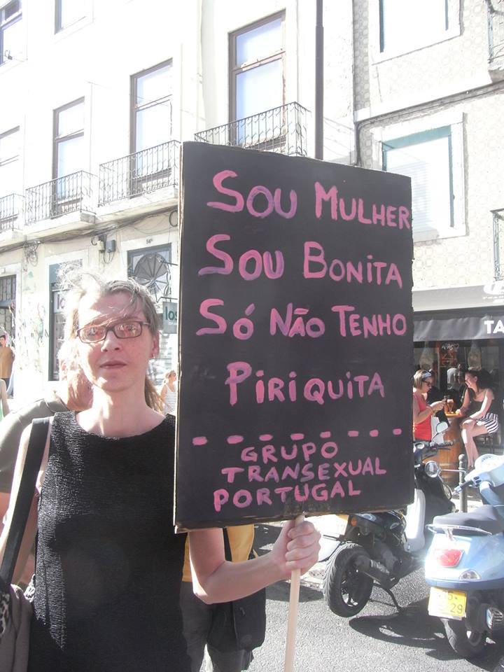 Lara Crespo carrying a political sign during an LGBTQ march.